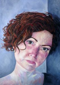 Portrait painting of a white man staring out into the viewer, with a peaceful but melancholic expression. Her round cheeks and nose are flushed a soft pink with her short auburn hair falling just below her eyes. The background is an ash blue colour, picks up the hints of blue painted in her skin.