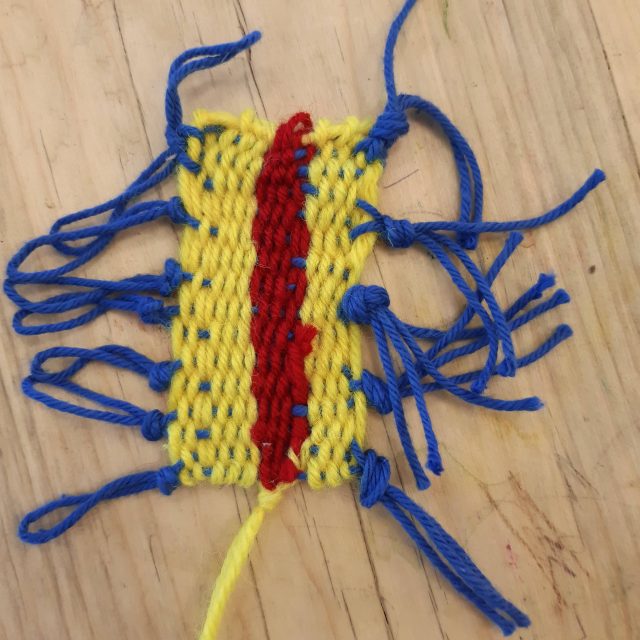 Weaved yarn in blue, red, and yellow.